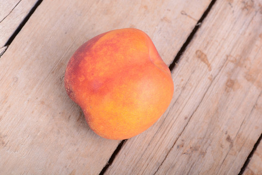 Nectarine fruit on old wooden plate background close up