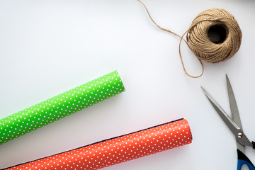 Process of package and wrapping Christmas and New Year gift box. Wrapping paper, scissors, twine on...
