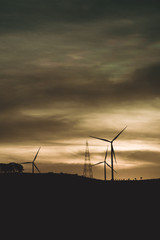 Wind turbine power generator silhouette at sunset