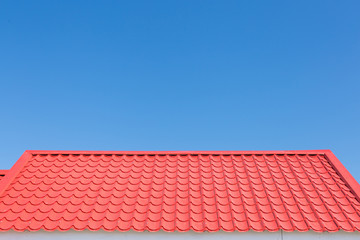 Red roof with blue sky background