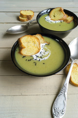 vegetarian cream soup of green vegetables. on a black background