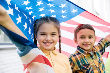 siblings with american flag