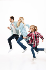 Fototapeta premium Full length portrait of a beautiful young family running