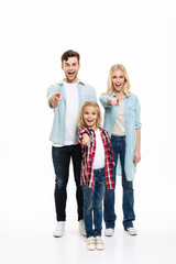 Fototapeta premium Full length portrait of a smiling family with a child
