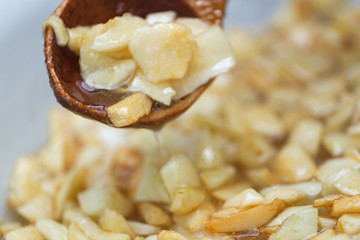 The process of preparing jam. Jam from apples. The hand of the cook mixes pieces of apples in sugar for cooking jam