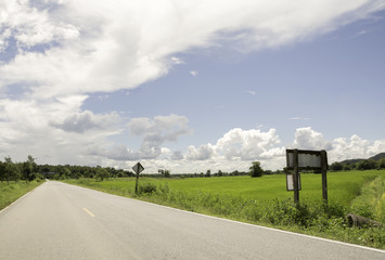 View on the road to a village in rural Thailand .