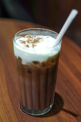 ice chocolate and milk foam on wooden table