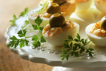 Spicy deviled eggs garnished with green olives