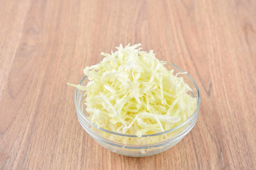 cabbage slices isolated on wooden table
