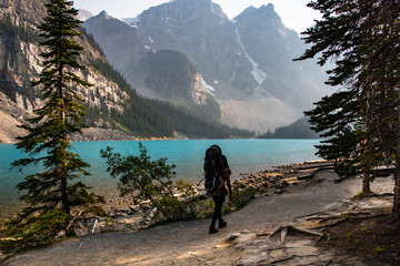 A silhouette of woman hiking near the lake - 178836203