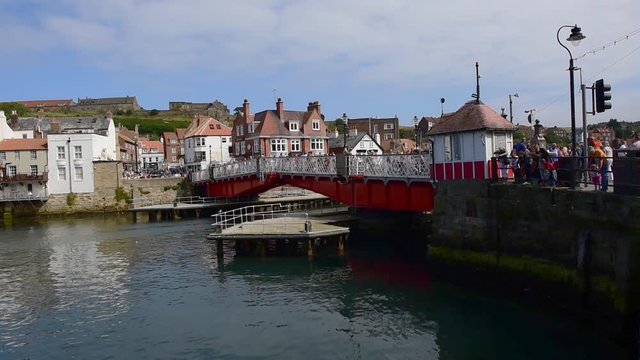 Pedestrians crossing the swing bridge at Whitby, North Yorkshire.
