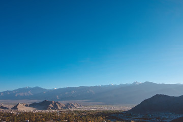 Landscape and building in Leh Ladakh city with mountains and blue sky background