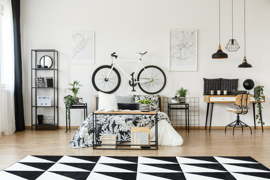 Desk and  bicycle in bedroom