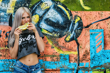 skinny blonde girl with fruits berry in pink 
