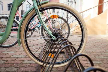 Vintage bicycle at parking, closeup wheel of retro bike