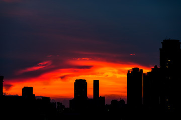 Fototapeta na wymiar Urban city sunset silhouette with sky scrapers.