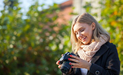Tourist girl looking at camera after taking picture, outdoor