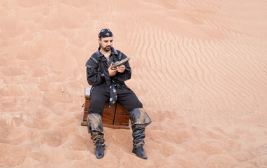 black pirate in a desert with treasure box