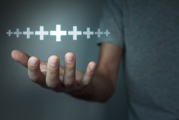Man showing plus sign.