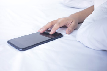 Young woman sleeping on bed with smartphone in morning.lifestyle concepts