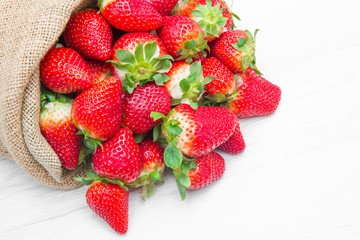 canvas sack full of  red strawberry