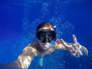 Underwater wide angle selfie of muscular swimmer with a lot of bulb