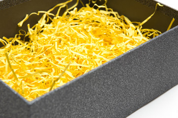 Black gift box with yellow packaging material