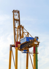 Fototapeta na wymiar Heavy industrial sea port container crane.
