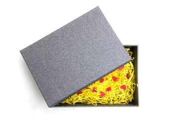 Black gift box with yellow packaging material and red heart model
