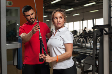 Middle aged woman working out with fitness coach