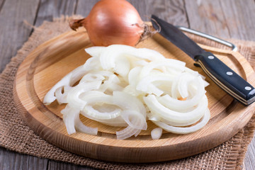 Chopped onions on wooden cutting board