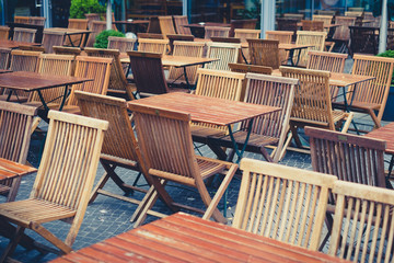 empty tables and chairs in restaurant on day off