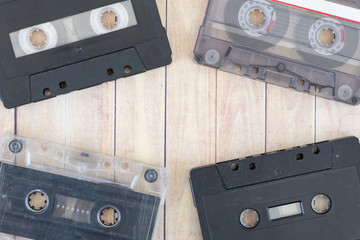 Old cassette tapes with a wooden background