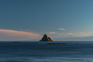 Fototapeta na wymiar Lonely mountain in the middle of an ocean