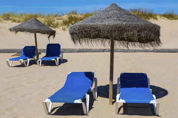 Sun Loungers and Umbrella on Beach