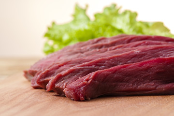 fresh meat on the table cut into pieces, close-up