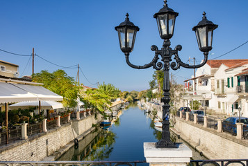 The canal or river in the greek town Lefkimmi, Ionian Islands, Corfu, Greece. Boats, restaurants,...