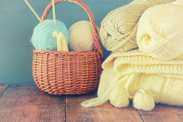 warm and cozy yarn balls of wool on wooden table.