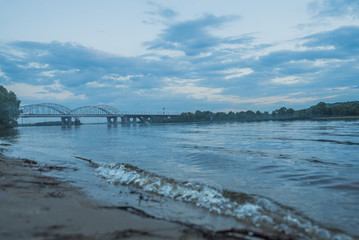 Reflection of bridge and sky on river