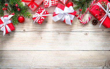 Christmas background with red gift boxes on wooden board