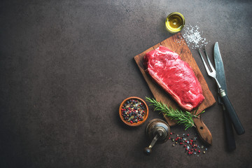 Raw ribeye beef steak with herbs and spices