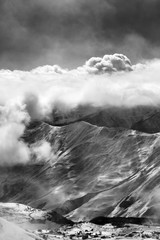 Black and white view on ski resort at mist with sunlight clouds