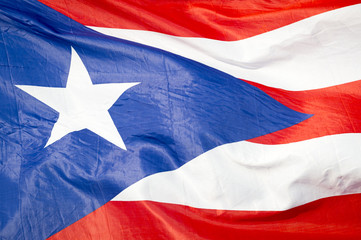 Abstract close-up view of flag of Puerto Rico fluttering in the breeze.