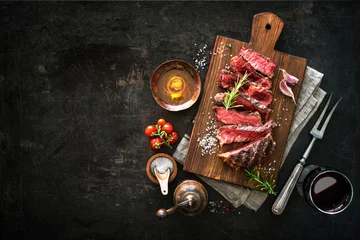 Gartenposter Sliced medium rare grilled beef ribeye steak © Alexander Raths
