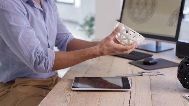  Designer working, creating 3D printed objects from computer software