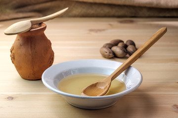 clay pot of honey next to the dish in which the honey