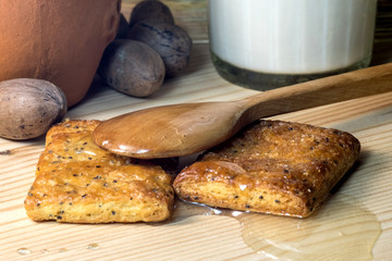 cookies, wooden spoon lying on biscuits spread with honey