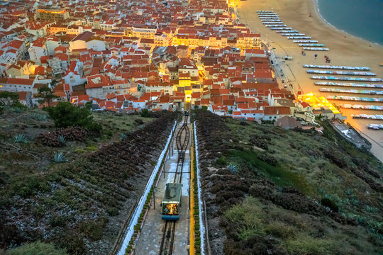Nazare, Portugal by evening, the most popular seaside resorts in Silver Coast. Prospective view of popular Ascensor da Nazare or Nazare Funicular from Nazare Sitio, the upper part of city.