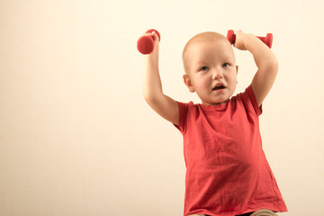 Children train with dumbbells. The concept of sport in the family.