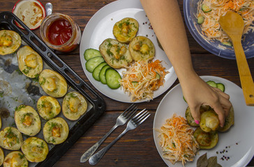 baked potatoes in a baking sheet on a wooden table top view